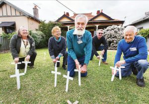 Photo of Shed members outside ANZAC Cottage.